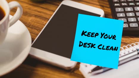 animation of keep your desk clean text on memo note over smartphone on desk