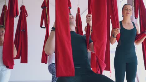 gentleman-with-ladies-relaxes-leaning-on-special-hammocks