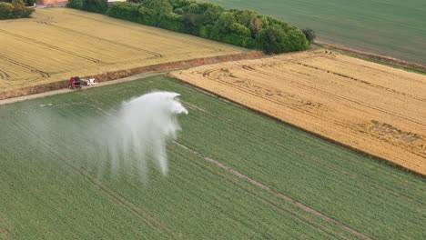 agricultural irrigation equipment waters soybean crops in po valley, italy, during spring, providing essential hydration for healthy growth, drone slow motion pan