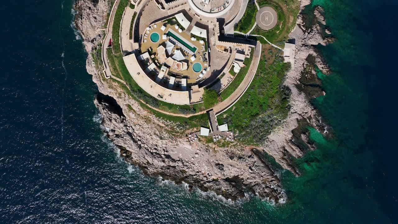 Aerial top shot above Mamula Island revealing circular fortress layout and natural coastline below