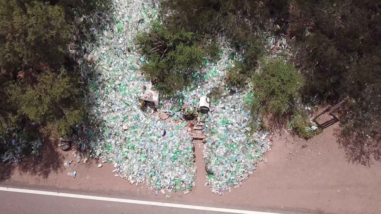 Aerial View of Plastic Waste Junkyard by Countryside Road in Argentina, Empty Bottles and Difunta Correa Saint Shrine