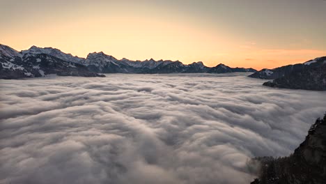 epic sea of fog rolls below snowy mountains at sunset arvenbüel switzerland