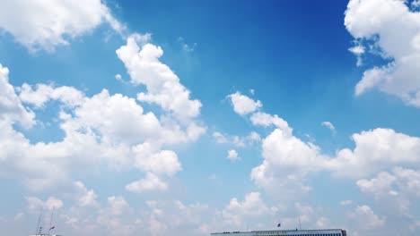 white puffy clouds and blue sky time-lapse with long second duration for background and graphics in daylight