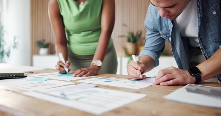 Colleagues Collaborating on Business Documents in Modern Office