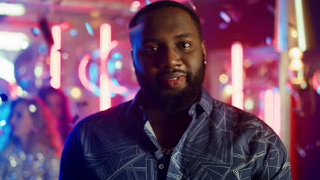 Relaxed-african-man-posing-at-party.-African-american-guy-having-rest-in-club.