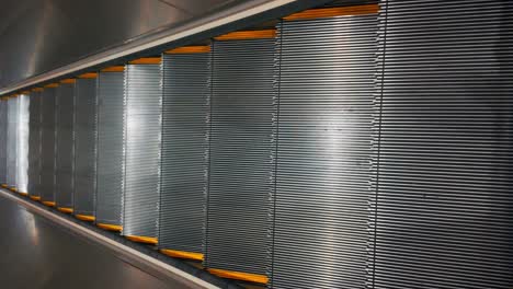 a vertical shot, looking down and going down on a well lit and shiny escalator