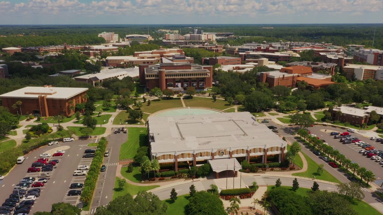 Veduta con drone ad alta quota del campus dell'Università della Florida Centrale, con Millican Hall, l'iconico Reflecting Pond e la John C. Hitt Library sullo sfondo.