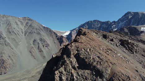 mountain aerial orbits ridge to reveal snowy alpine cirque, argentina