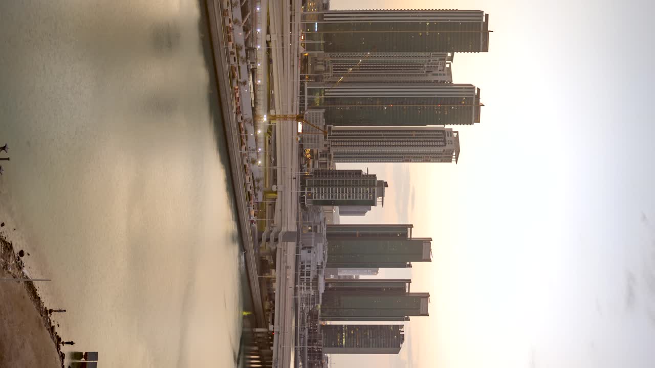 Abu Dhabi, United Arab Emirates city skyline golden sunrise time lapse - vertical orientation