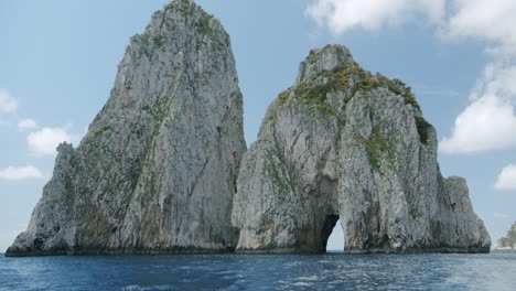 a beautiful visual from a boat of the faraglioni in capri during a day in spring