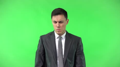 businessman in suit thinking and counting on green screen