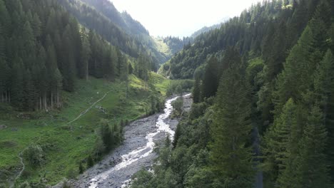 dried up river from ascended level of a great mountain left tiny flow stream of aqua global warming climate change natural cycles of life small footpath on the side up the hill pure greenery sunny