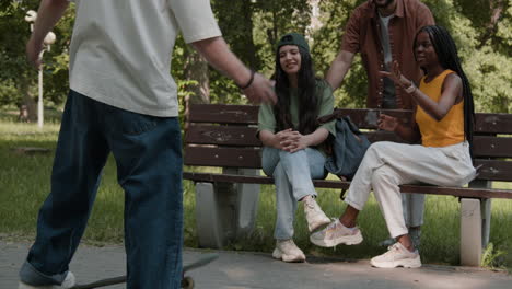 young people skateboarding and socializing in a park