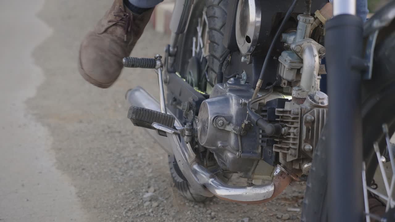 Person working on a vintage motorcycle