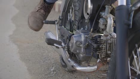 person working on a vintage motorcycle