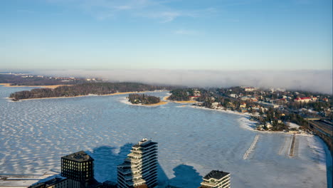 Timelapse-of-Sea-fog-moving-over-the-Kulosaari-island,-sunny-day-in-icy-Helsinki