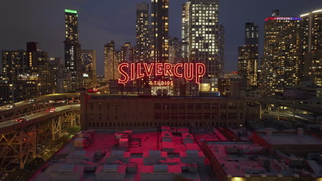 silvercup studios at night - aerial view of nyc skyline