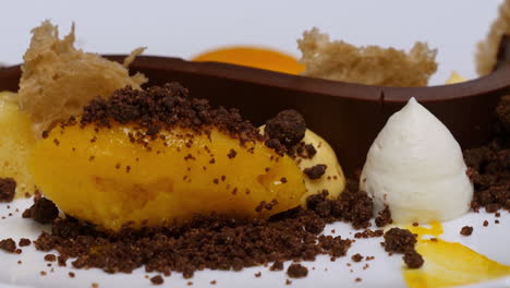 gourmet mango sorbet dessert with chocolate and whipped cream