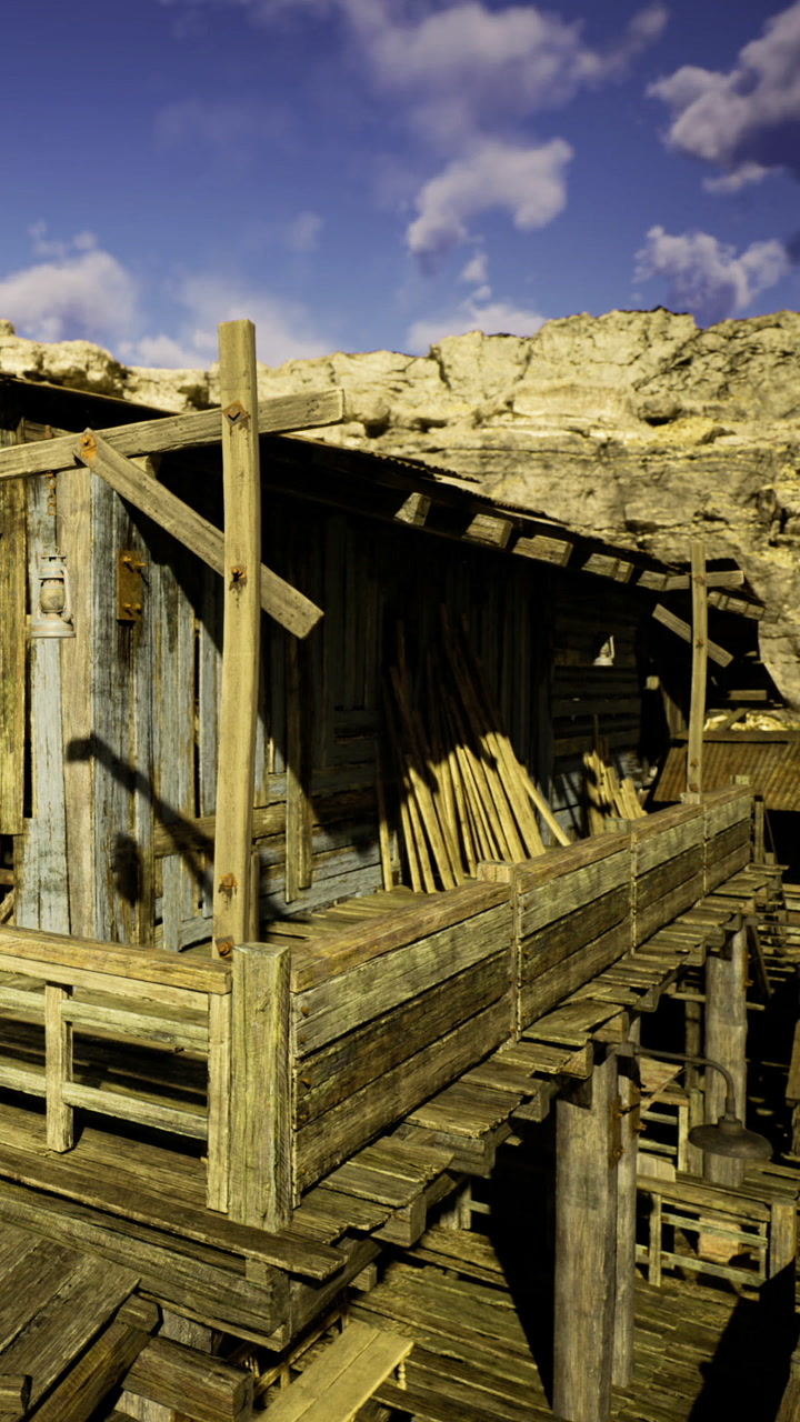 Rustic wooden structure stands tall against a rocky backdrop in the sun
