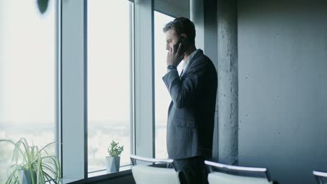 businessman talking on a phone in a modern office