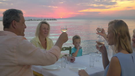 family dinner by the sea at sunset