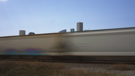 time lapse of cargo train passing by downtown houston, texas