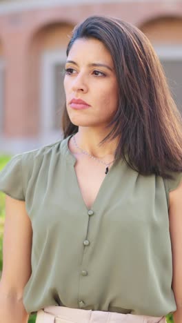 serious woman portrait outdoors with crossed arms