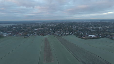 Flying-towards-distant-town-in-a-beautiful-Dutch-rural-landscape