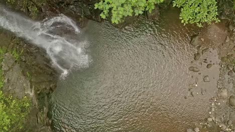 Paradise-Meets-Nature-in-Alegria-with-Lumondo-Waterfall-Cascading-Over-the-Cliff-into-a-Pool-of-Water