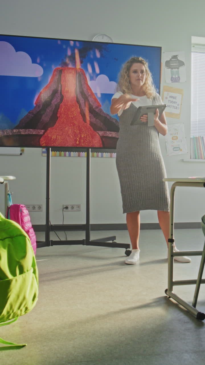Geology Class Female Teacher Teaching Primary School Children Using Digital Screen