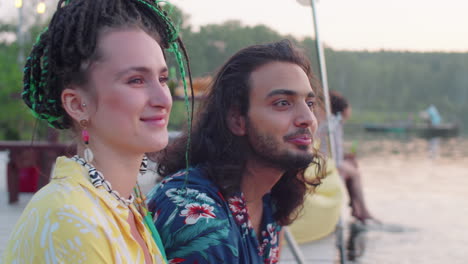 Multiethnic Couple Smiling and Chatting on Lake Pier