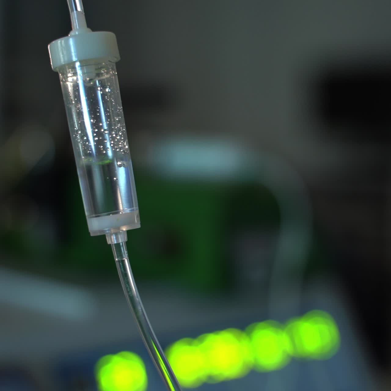 Medicines drops trickling slowly in the drop counter. Medications for the patient during neurosurgical operation. Close up