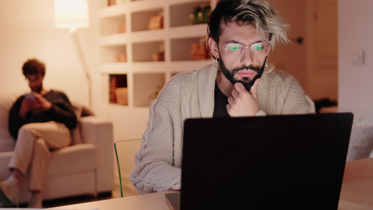 Gay Couple at Home Working and Relaxing