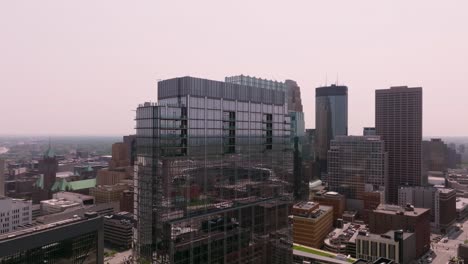 a drone captures the iconic four seasons hotel in downtown minneapolis against the backdrop of the city skyline