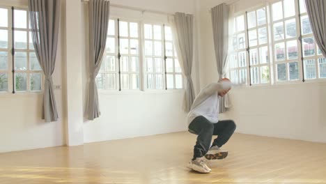 young man hipster is performing breakdance show in studio, video in 4k 50fps