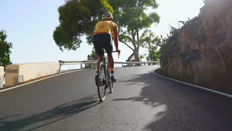 with an empty road ahead, a man rides his road bike in the morning, pursuing outdoor exercise. the slow-motion perspective intensifies the vibe of extreme sports