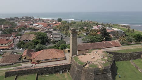 Aerial-orbits-Galle-Fort-clock-tower-and-stone-fortifications-on-coast