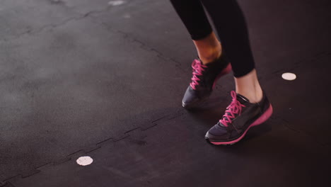 Low-Section-Of-Young-Woman-Jogging-In-Place-During-Fitness-Training