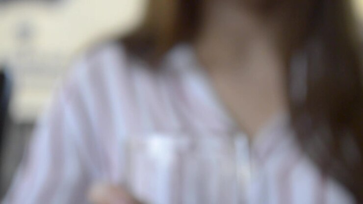 Girl grabbing a glass of cold water and drinking it, TILT UP going out of focus