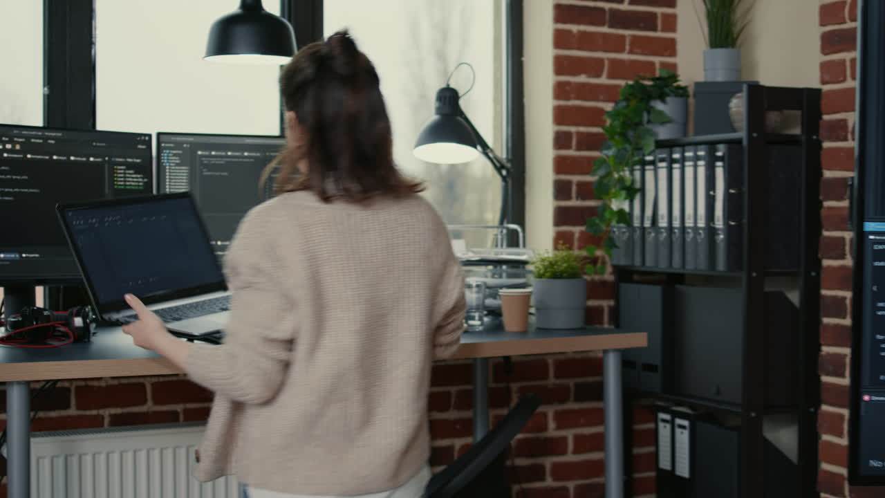 Team of software engineers leaving after analyzing source code on wall screen tv comparing errors