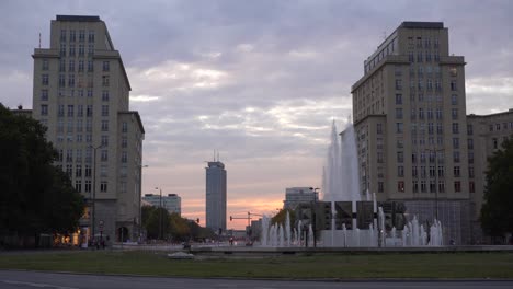 Beautiful-sunset-with-orange-tones-in-east-berlin-with-water-fountain