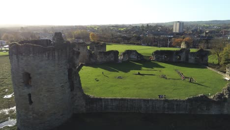 Historical-Flint-castle-medieval-military-ruins-landmark-aerial-view-close-pan-left-into-orbit