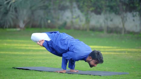 indian man doing peacock yoga pose