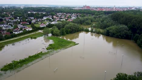 aerial view of flooded soccer field and residential area