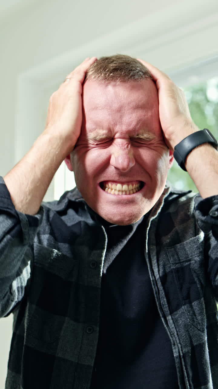Emotional portrait of a man close-up. Male face with a scream and anger emotions. An irritated man looks into the frame