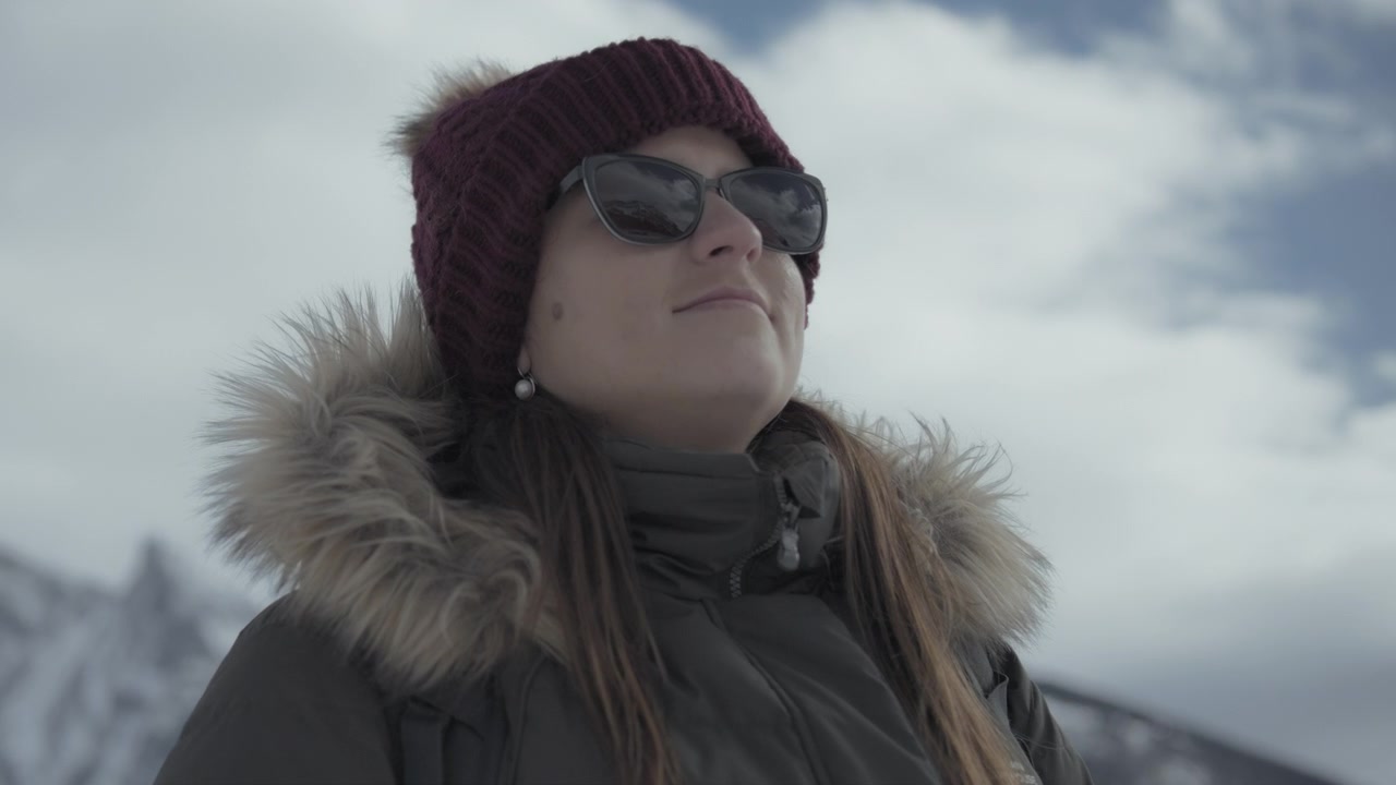Young hiker walking outdoors in winter surrounded by Rocky Mountains