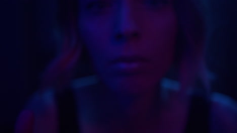 a young woman appears through glittering curtain