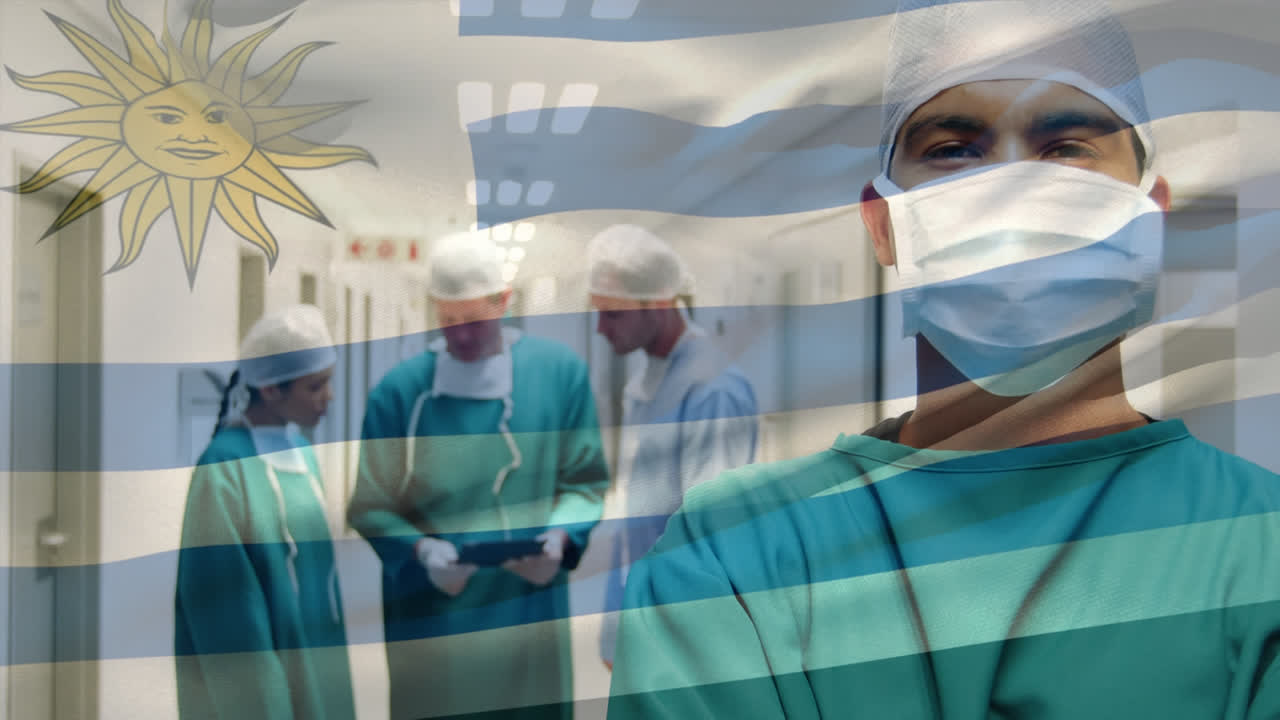 Animazione di una bandiera dell'Uruguay che sventola su ritratto di un chirurgo maschio birazziale con mascherina chirurgica in ospedale