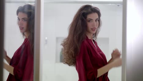 with an air of mystery and elegance model throws her hair back before posing