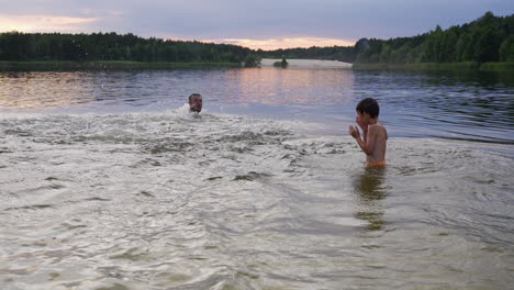 father and son swimming on the beach